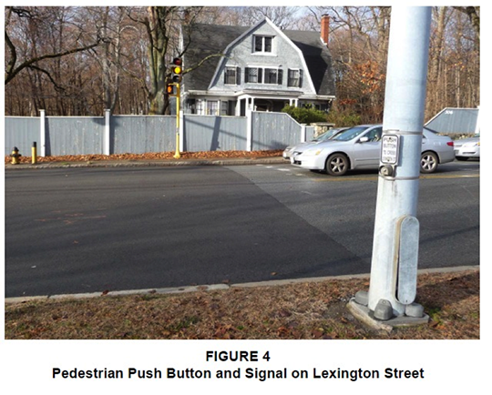 Figure 4. Figure 4, titled “Pedestrian Push Button and Signal on Lexington Street,” is a photograph, taken from the side of the road, that shows a pole with a pedestrian push button, but there is no crosswalk.