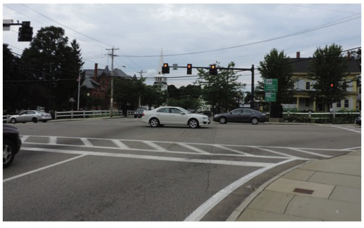 Figure 2 is titled "Intersection Overview: Northbound Approach.” It is a photograph taken from the perspective of a northbound driver approaching the traffic signal at the intersection.
