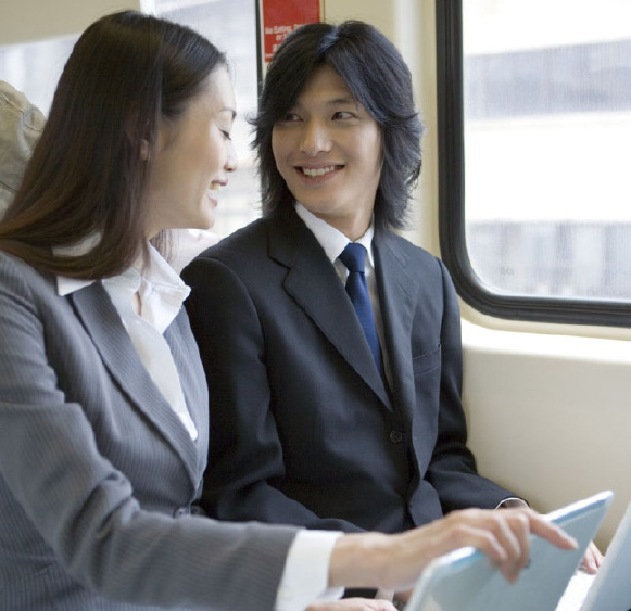 A picture of customers using their laptops on a commuter rail train.