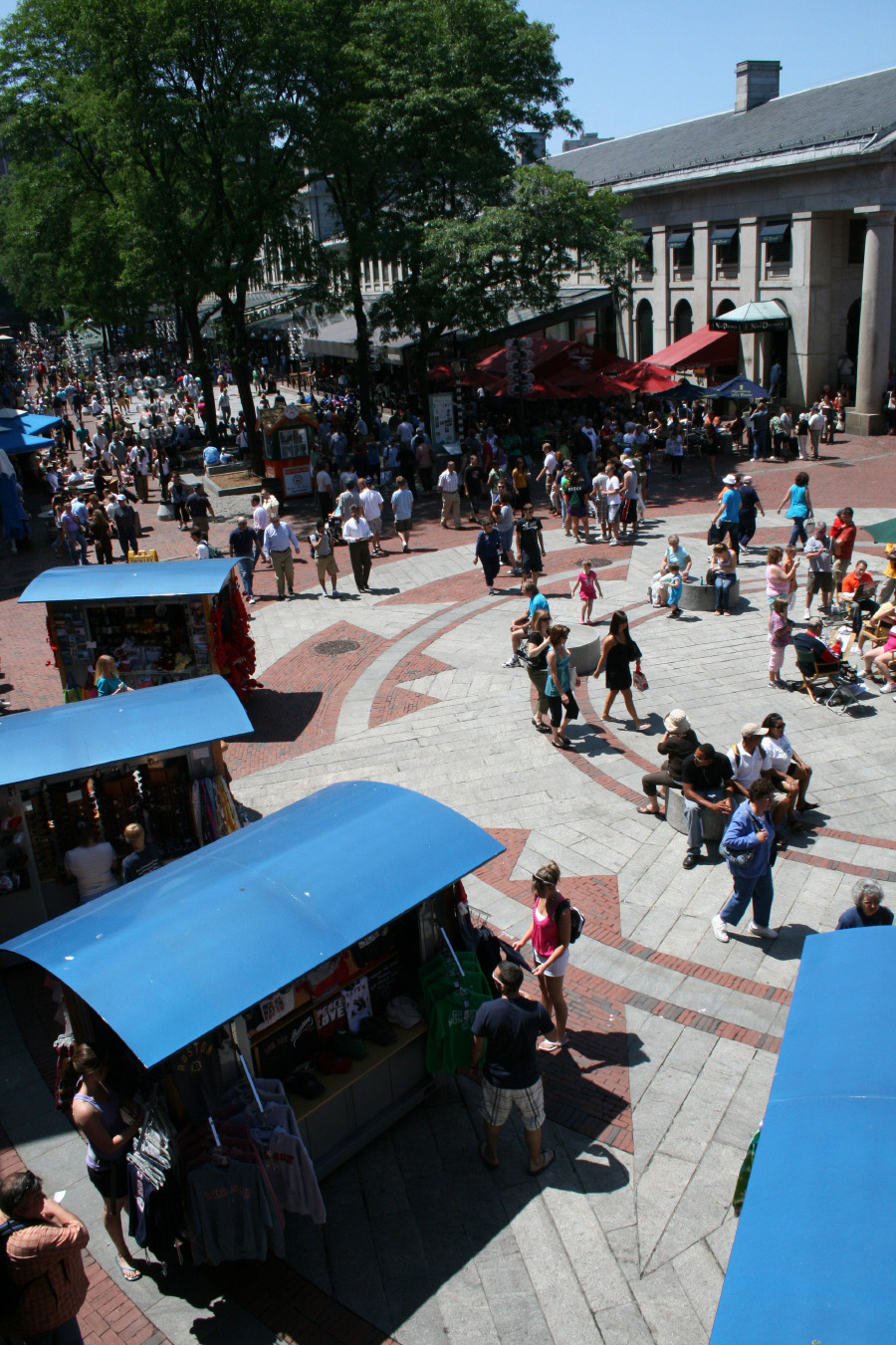 A picture of pedestrians walking through Quincy Market.