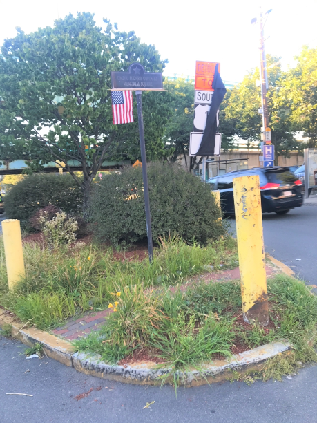 The narrow sidewalks and lack of curb ramps on the intersection island are not ADA-accessible.