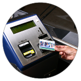 Image of a hand tapping a CharlieCard on a MBTA fare machine.