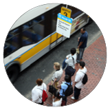 A photograph of people waiting an MBTA bus stop.