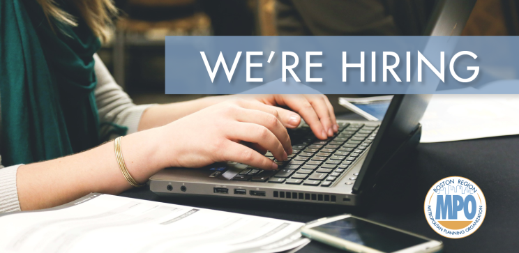 Image of a professional on a laptop with the text "We're Hiring"